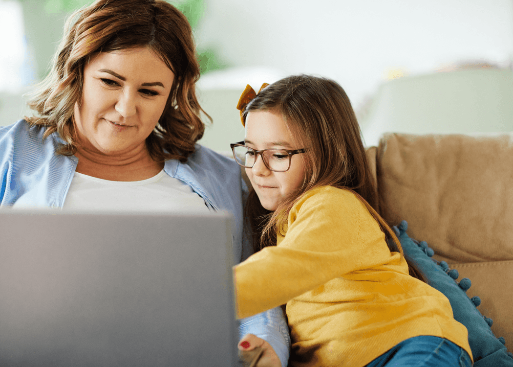 Adult and a child reading together.